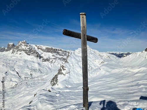 summit cross mountain Rotspitz above Partnun St.Antönien and Gargellen. Ski mountaineering in the Swiss Alps. Snow covered mountains. High quality photo photo