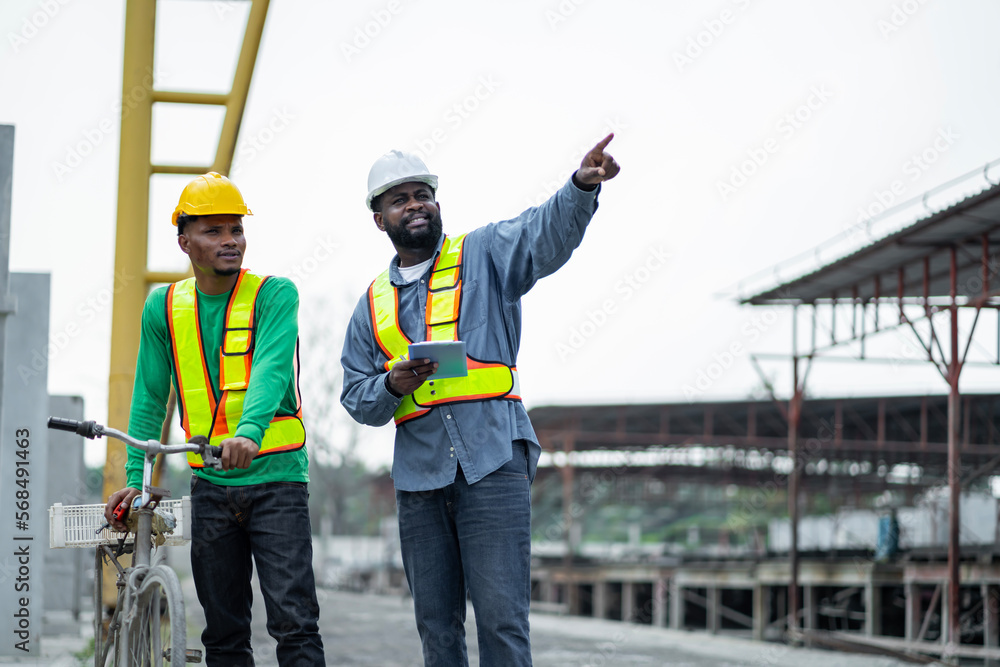 Male engineers are inspecting and controlling the work of the employees and the quality of the manufactured products to meet the standards In industrial factories producing precast prefabricated walls Male engineers are inspecting and controlling the work of the employees and the quality of the manufactured products to meet the standards In industrial factories producing precast prefabricated walls