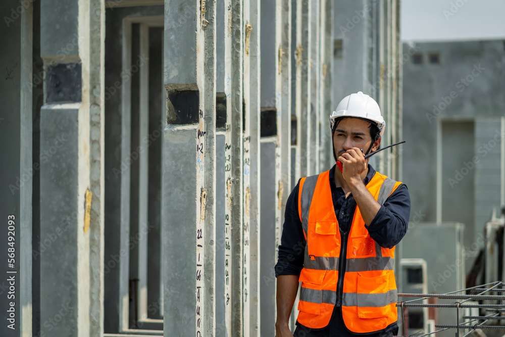 Male engineers are inspecting and controlling the work of the employees and the quality of the manufactured products to meet the standards In industrial factories producing precast prefabricated walls Male engineers are inspecting and controlling the work of the employees and the quality of the manufactured products to meet the standards In industrial factories producing precast prefabricated walls