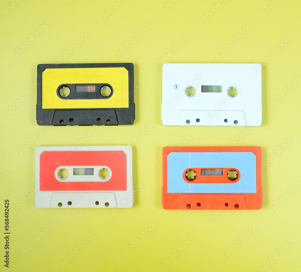 a large collection of retro cassette tapes places in a grid on green background