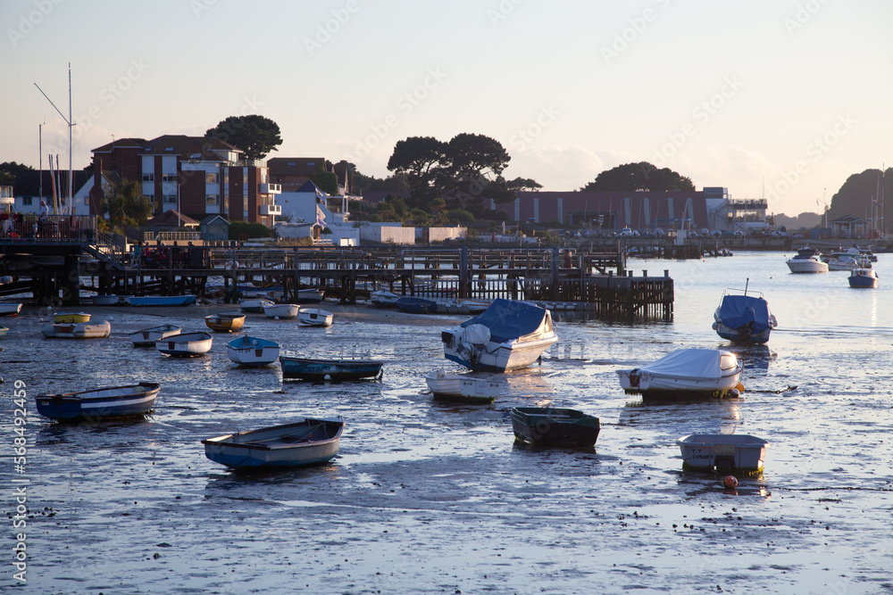 Obraz premium Small boats resting on the mud at low tide, sandbanks in Poole