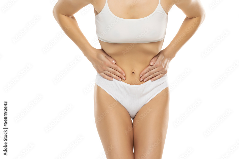 Gynecology concept. Young woman suffering from pain, white studio background