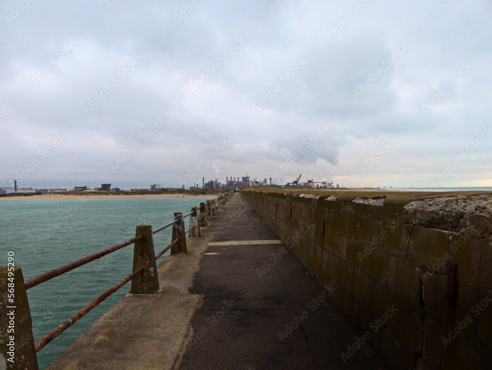 January 2023, Dunkerque - Winter walk on the Break dam - View on an industrial site	
