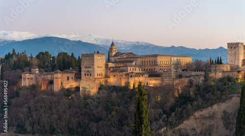 Alhambra historical monument at sunset with Sierra Nevada and its snowy mountains in the background. Photo taken from San Nicolas viewpoint in Granada, Andalusia, Spain © Alberto