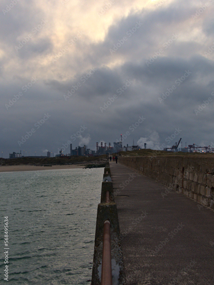 January 2023, Dunkerque - Winter walk on the Break dam - View on an industrial site	
