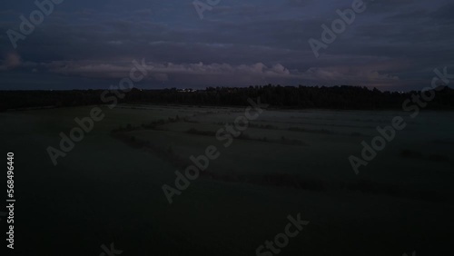 A car driving down a street at night. Drone view