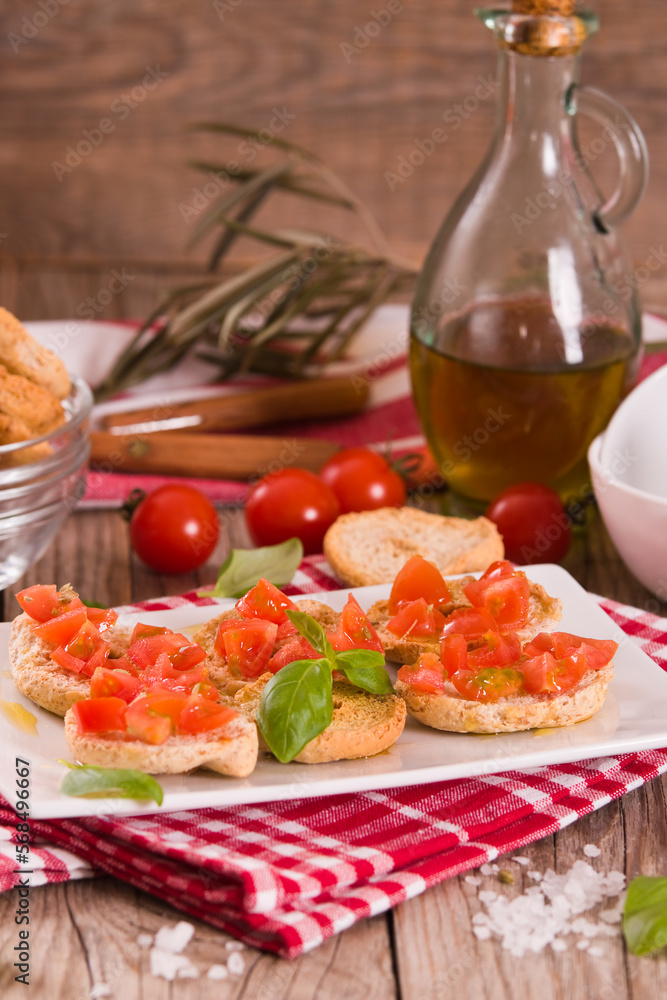 Friselle with cherry tomatoes and basil. Friselle with cherry tomatoes and basil.