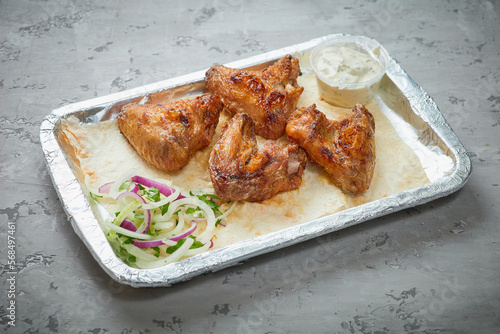 Chicken wings in a plate on a concrete background