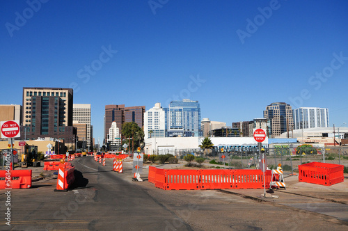 Northbound view of downtown Phoenix, Arizona skyline  from light rail extension construction zone showing do not enter traffic sign and orange barricades photo