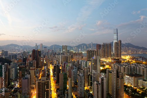 Scenery of Hong Kong viewed from Mong Kok in Kowloon area, with a city skyline of crowded skyscrapers along Victoria Harbour & a brilliant cityscape of street lights glistening in twilight before dawn
