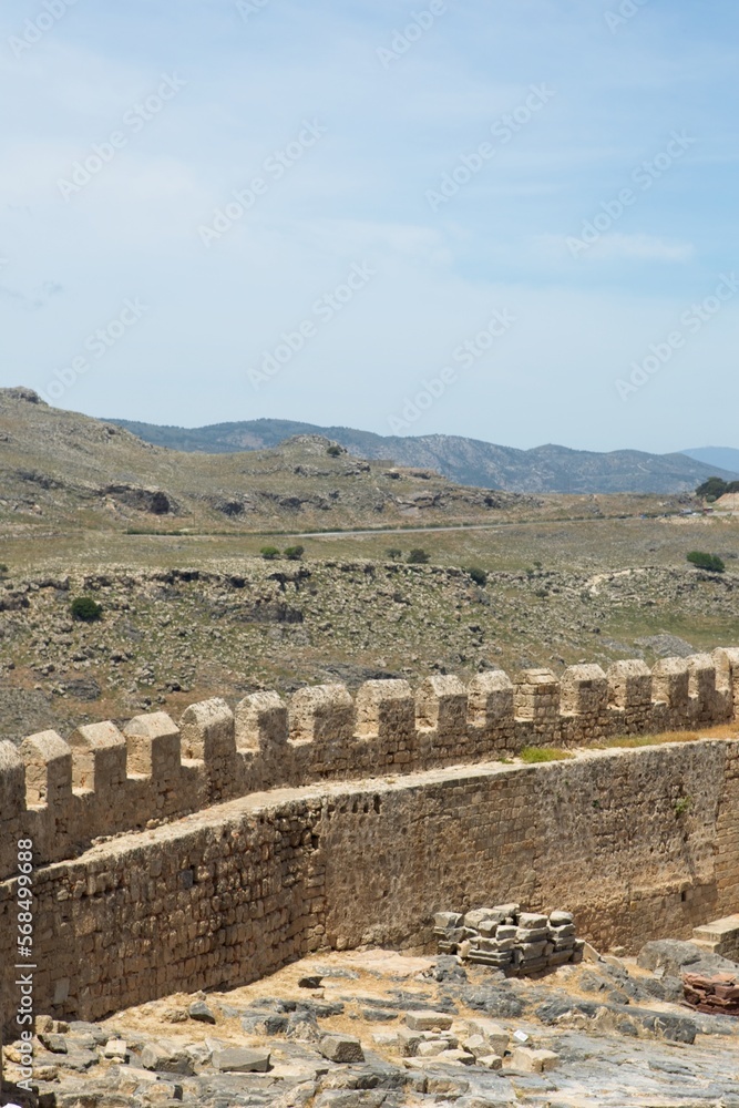 Stone wall of Lindos ancient acropolis and medieval castle in sunny spring weaher, Rhodes, Greece.
