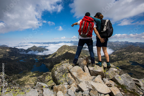 Young hiker couple in Ratera peak, Aiguestortes and Sant Maurici National Park, Spain