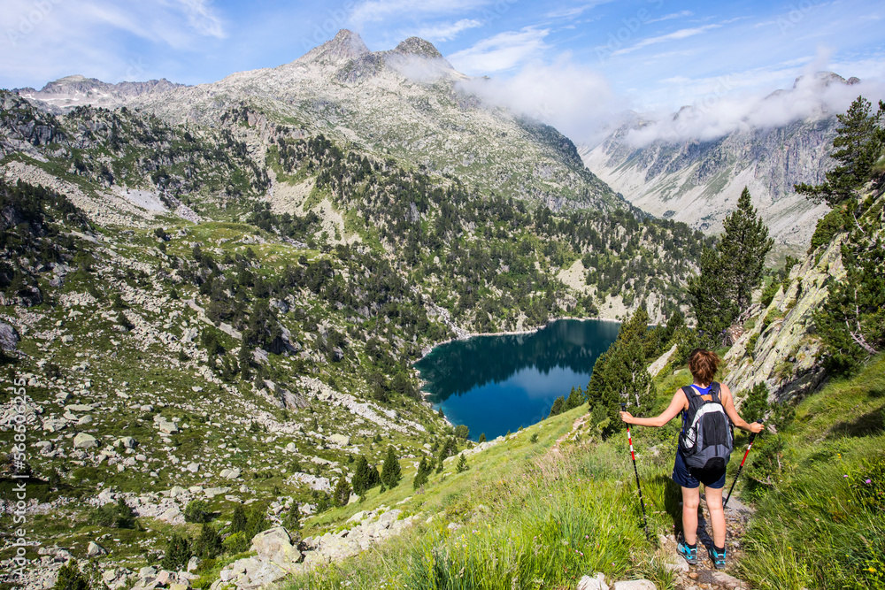 Young hiker girl summit to Montardo Peak in AIguestortes and Sant Maurici National Park, Spain