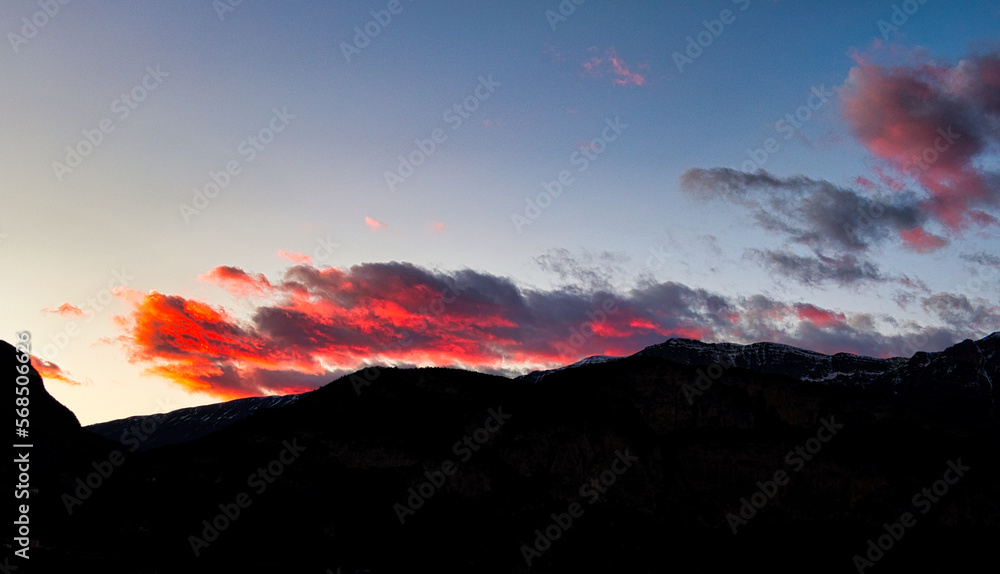 Red sunset over the mountains of the Adige valley, Trentino, Italy.