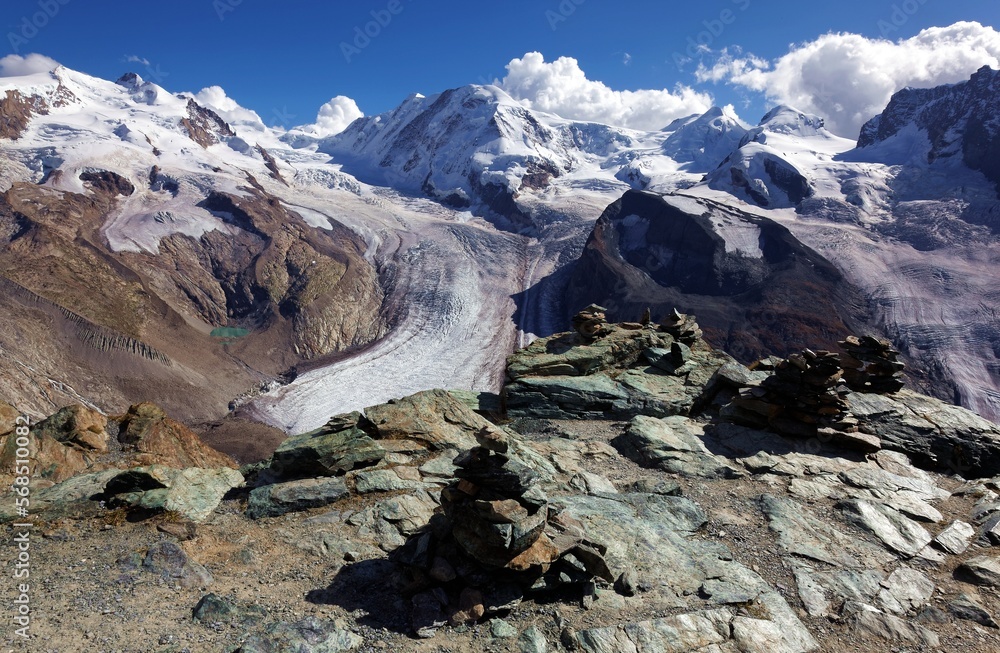 Fototapeta premium Cairn and the Gorner Glacier,a valley glacier on the west side of the Monte Rosa Massif,close to Zermatt, Switzerland. The second largest glacial system in the Alps after the Aletsch Glacier system.