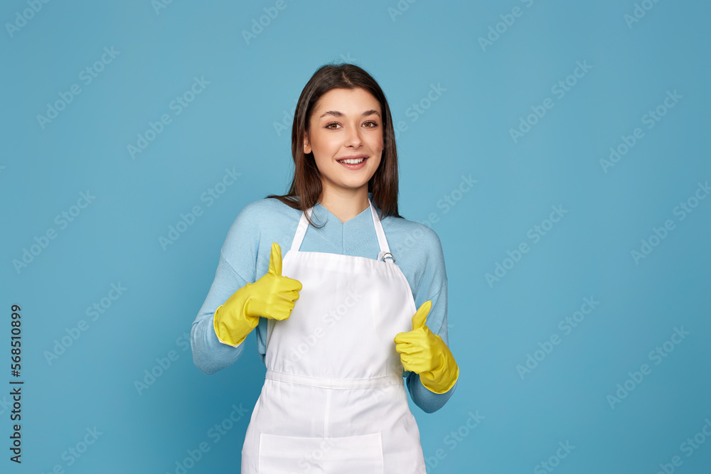 woman in rubber gloves and cleaner apron showing ok sign woman in rubber gloves and cleaner apron showing ok sign