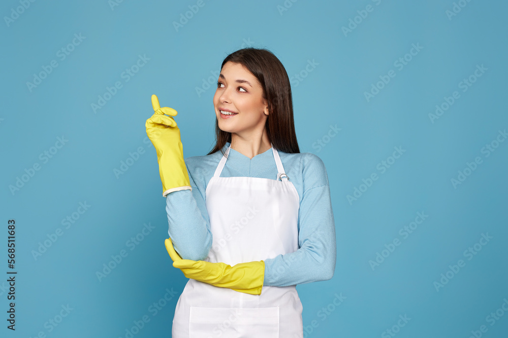 woman in apron holding index finger up with new idea woman in apron holding index finger up with new idea