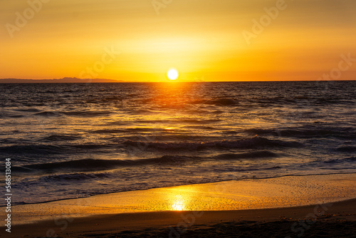 A beautiful glowing sunset in Laguna Beach, California. © GregLara