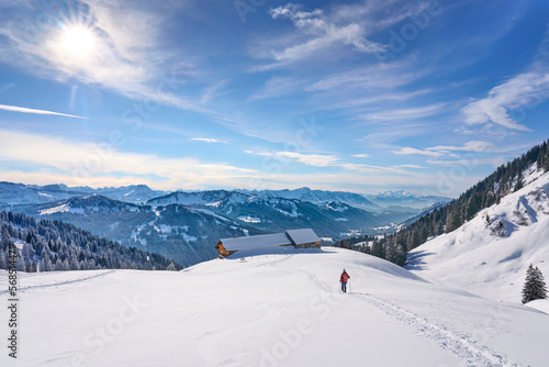 nice and active senior woman snowshoeing in deep powder snow in themountains of the Allgau alps near Balderschwang  Bavaria  Germany 