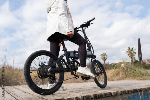 anonymous woman relaxed posing with the bike