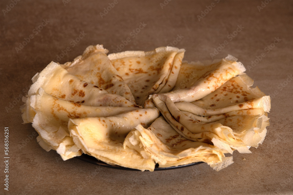 photo thin fried pancakes stacked in triangles in a circle photo thin fried pancakes stacked in triangles in a circle