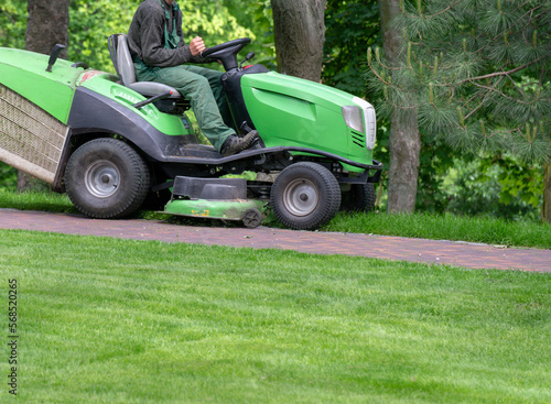 Professional lawn mower cuts the grass