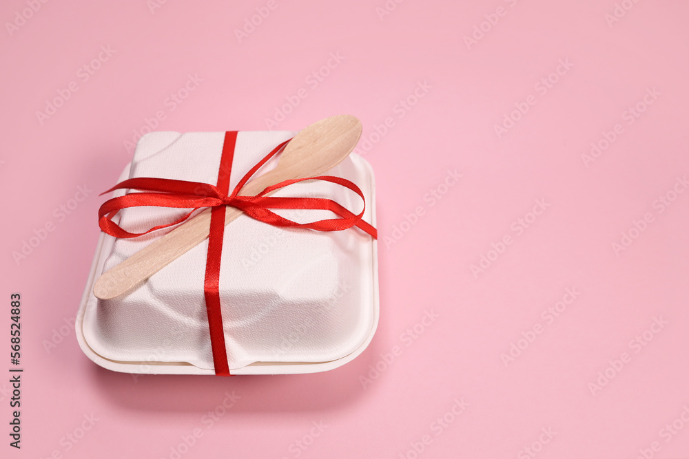 Cardboard box with bento cake tied with a ribbon and a wooden spoon. Birthday gift Cardboard box with bento cake tied with a ribbon and a wooden spoon. Birthday gift