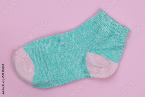 Baby sock on a pink background