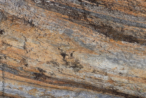 Gold brown and grey stone patterns with stripes from riverbed of Vale Verzasca in Switzerland