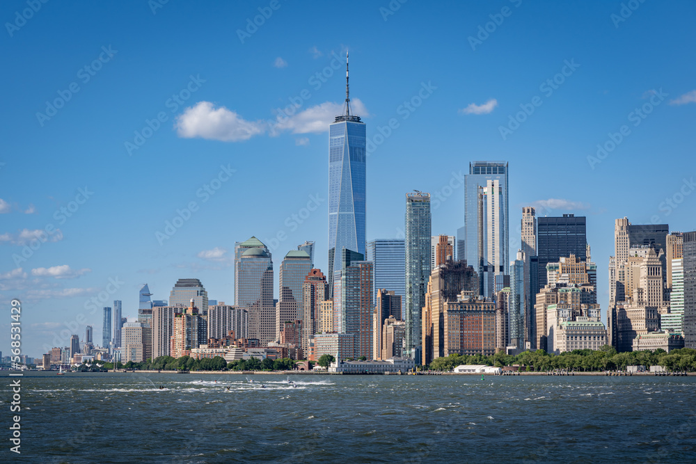Freedom tower and lower Manhattan panorama from a ferry on the Hudson river on a summer day