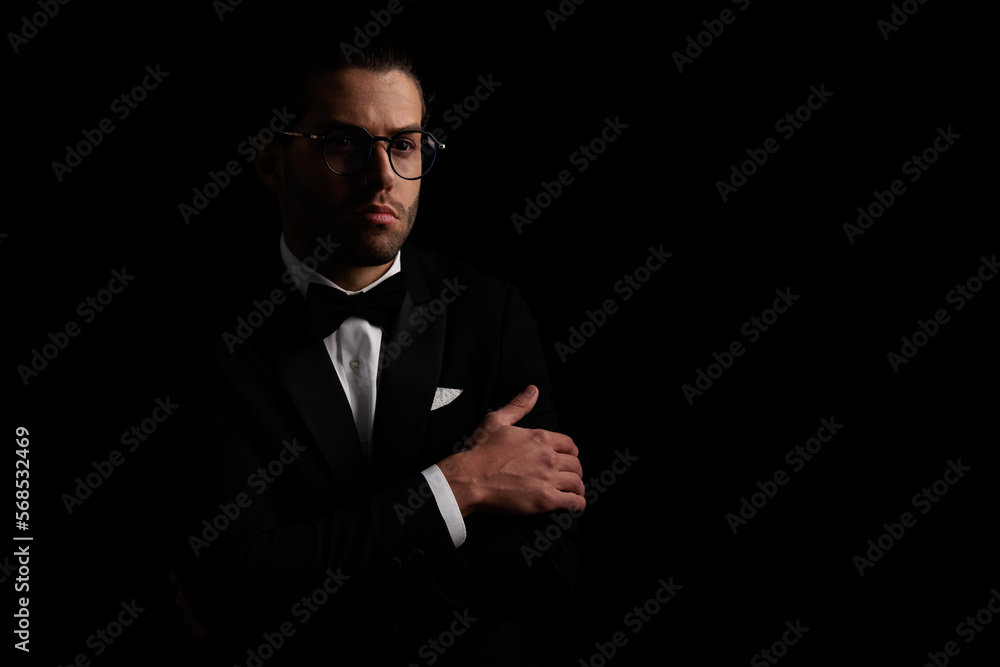 pensive elegant groom in tuxedo looking away and thinking pensive elegant groom in tuxedo looking away and thinking