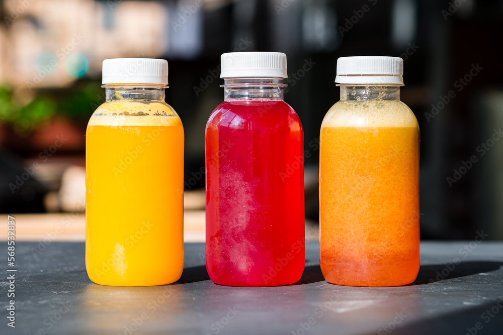 Freshly squeezed orange, carrot and cranberry juice in a plastic bottle. Freshly squeezed orange, carrot and cranberry juice in a plastic bottle.
