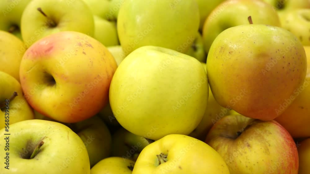 Fresh juicy appetizing yellow apples on the store shelf. Harvesting. Apples on the counter of the farm store. Close-up. Fresh juicy appetizing yellow apples on the store shelf. Harvesting. Apples on the counter of the farm store. Close-up.