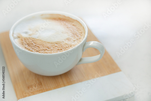 One large white cup of delicious fragrant cappuccino or latte coffee