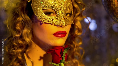 Woman with gold masquerade mask dancing  photo