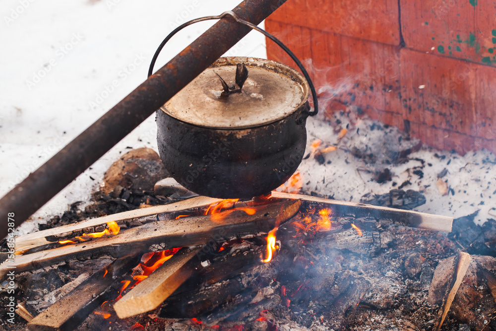Smoky cauldron hangs over an open fire, Smoky cauldron hangs over an open fire,