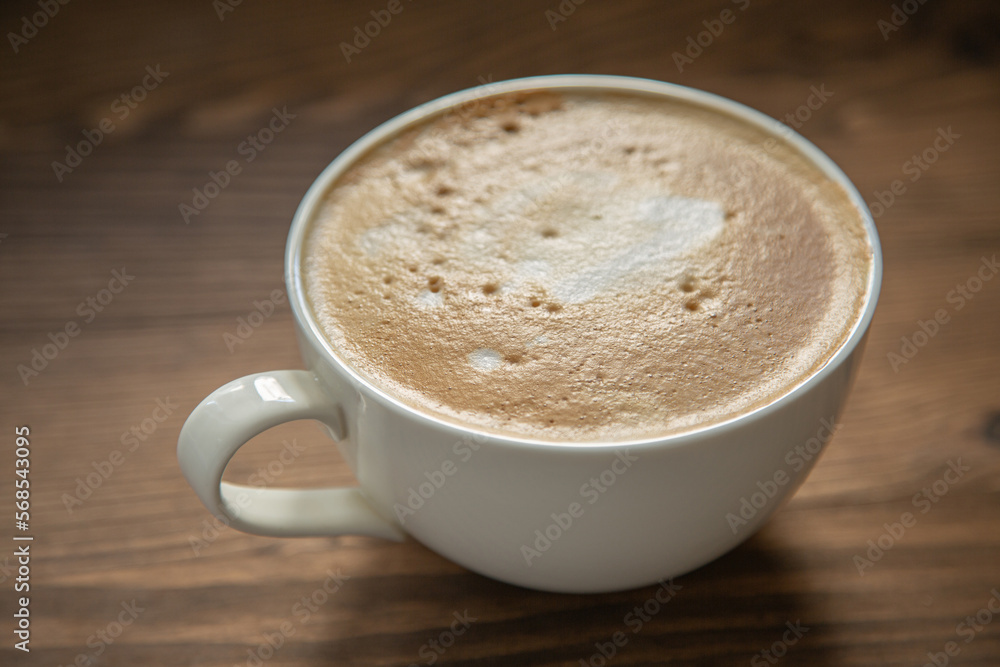 One large white cup of delicious fragrant cappuccino or latte coffee One large white cup of delicious fragrant cappuccino or latte coffee