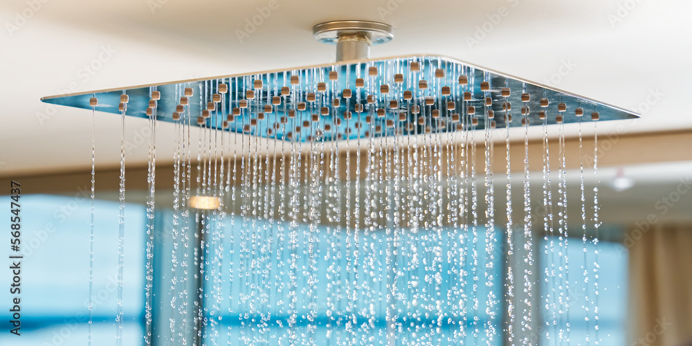 Water flows from the tropical shower. Large water consumption. Chrome large shower head, modern