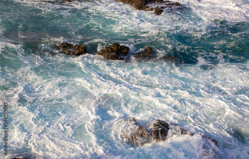 A close-up of the foaming sea water between the rocks © sebi_2569
