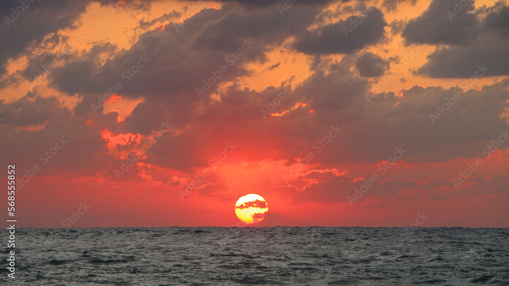 Sunset by the Mediterranean Sea. Red sunset sky nature background Sunset by the Mediterranean Sea. Red sunset sky nature background