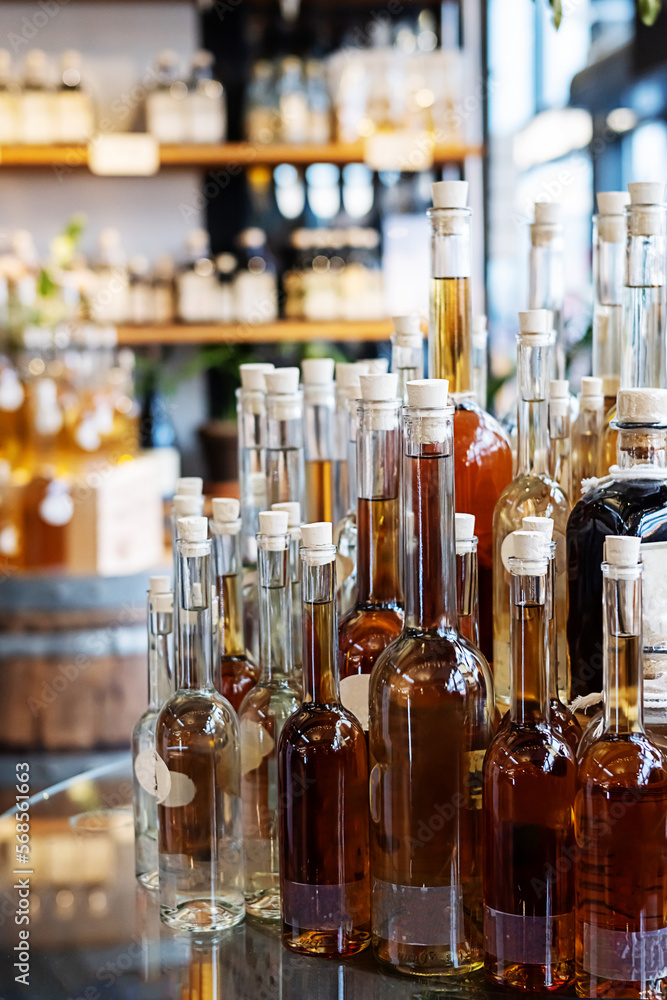 Bottles with alcoholic drinks and shelves with cognac, gin and rum. Bottles with alcoholic drinks and shelves with cognac, gin and rum.