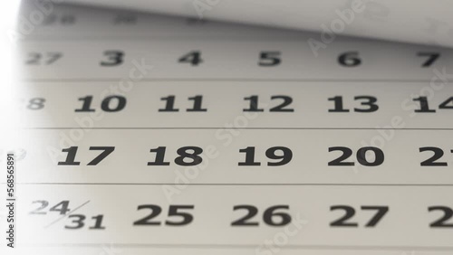 flipping through the pages of the flip calendar. 