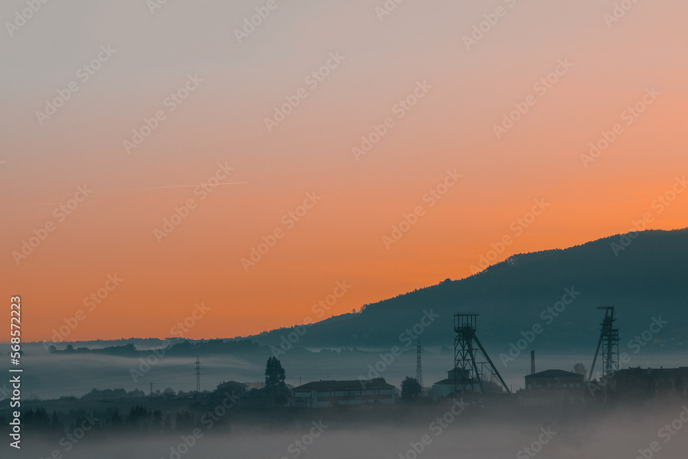 Fototapeta premium Precious metals and rare earths mine in the middle of the fog at sunset on golden hour