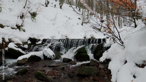 A waterfall on the northern slopes of the Polonyna Borzhava mountain massif at the foot of Mount Gemba in the Ukrainian Carpathians. Shypit waterfall. Winter in the mountains of Ukraine photo