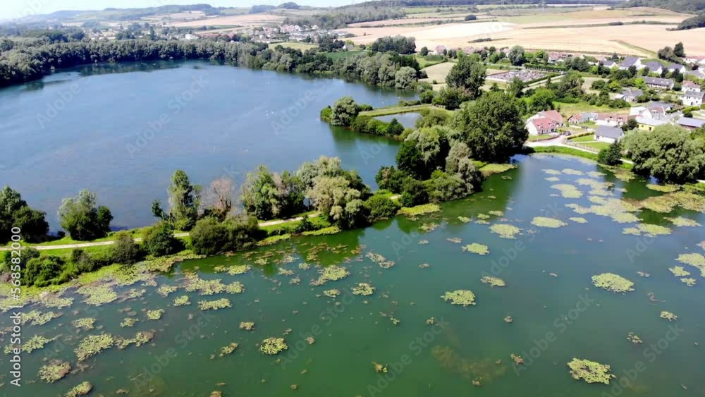 Aerial drone view of a lake in Normandy, France. Beautiful French countryside with green fields and meadows. Rural landscape Aerial drone view of a lake in Normandy, France. Beautiful French countryside with green fields and meadows. Rural landscape