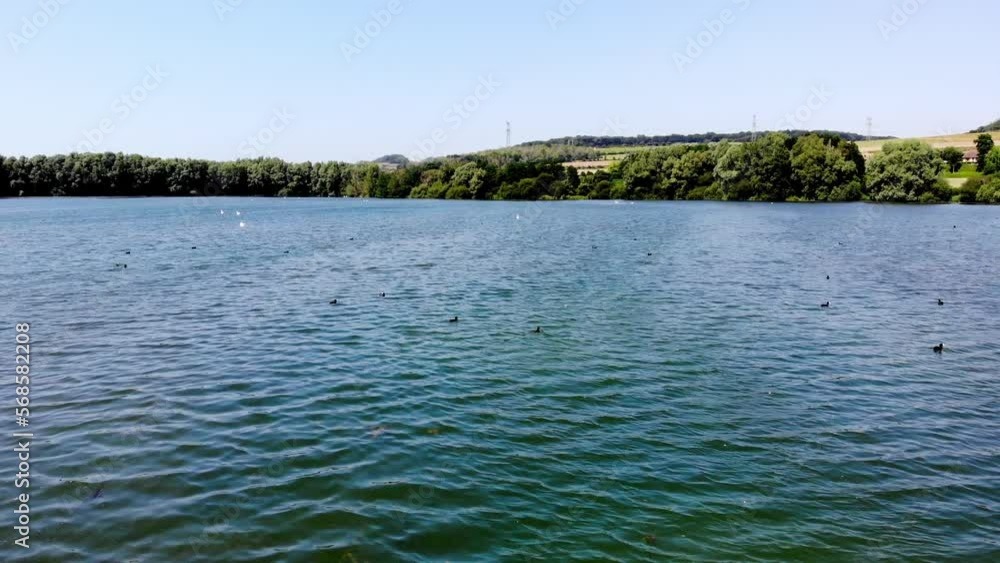 Aerial drone view of a lake in Normandy, France. Beautiful French countryside with green fields and meadows. Rural landscape Aerial drone view of a lake in Normandy, France. Beautiful French countryside with green fields and meadows. Rural landscape