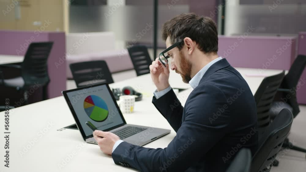 Close-up view of caucasian CEO analyzing big data report on his laptop indoors. Portrait of adult caucasian man brainstorming new ideas. High quality 4k footage Close-up view of caucasian CEO analyzing big data report on his laptop indoors. Portrait of adult caucasian man brainstorming new ideas. High quality 4k footage