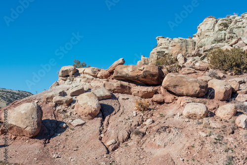 A desert hill with boulders, copy space in the blue sky on the left