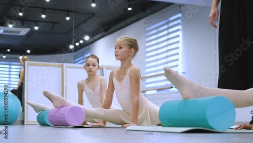 class of girls at the ballet school stretching