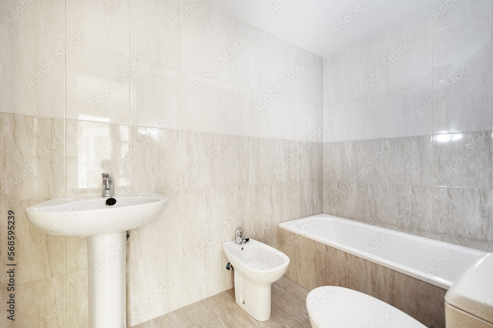Fototapeta premium A bathroom with a simple design with its four white porcelain toilets